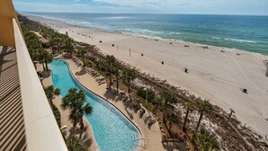 A beach resort with a swimming pool, beach, and ocean view.