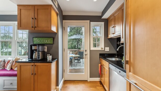 A modern kitchen with wooden cabinets, a coffee machine, and a sign that says "fresh PRODUCE". - Del Ray Designer Home walk to Shops, Cafes, Fun (Alexandria)