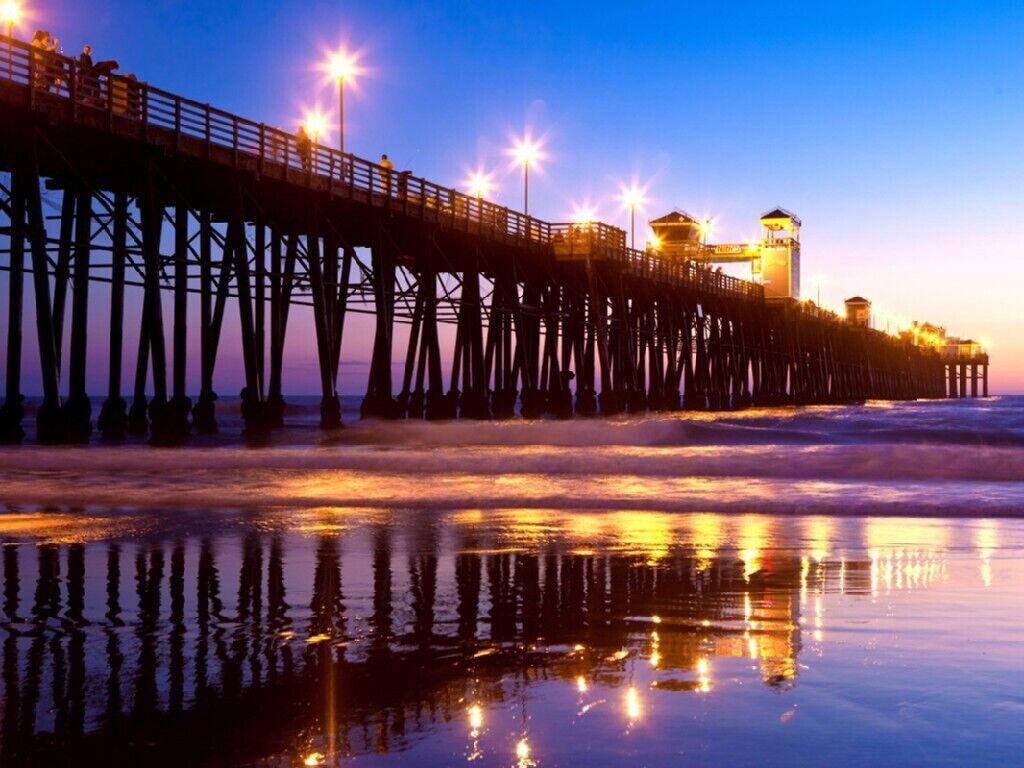 A pier extending into the water with a lighthouse at the end.