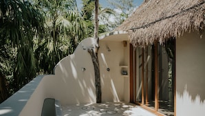 A modern, secluded bathroom with a thatched roof, surrounded by lush greenery. - Zorba Villa 3, Stunning 3BR Villa with private rooftop patio! Sleeps 8. (Tulum)