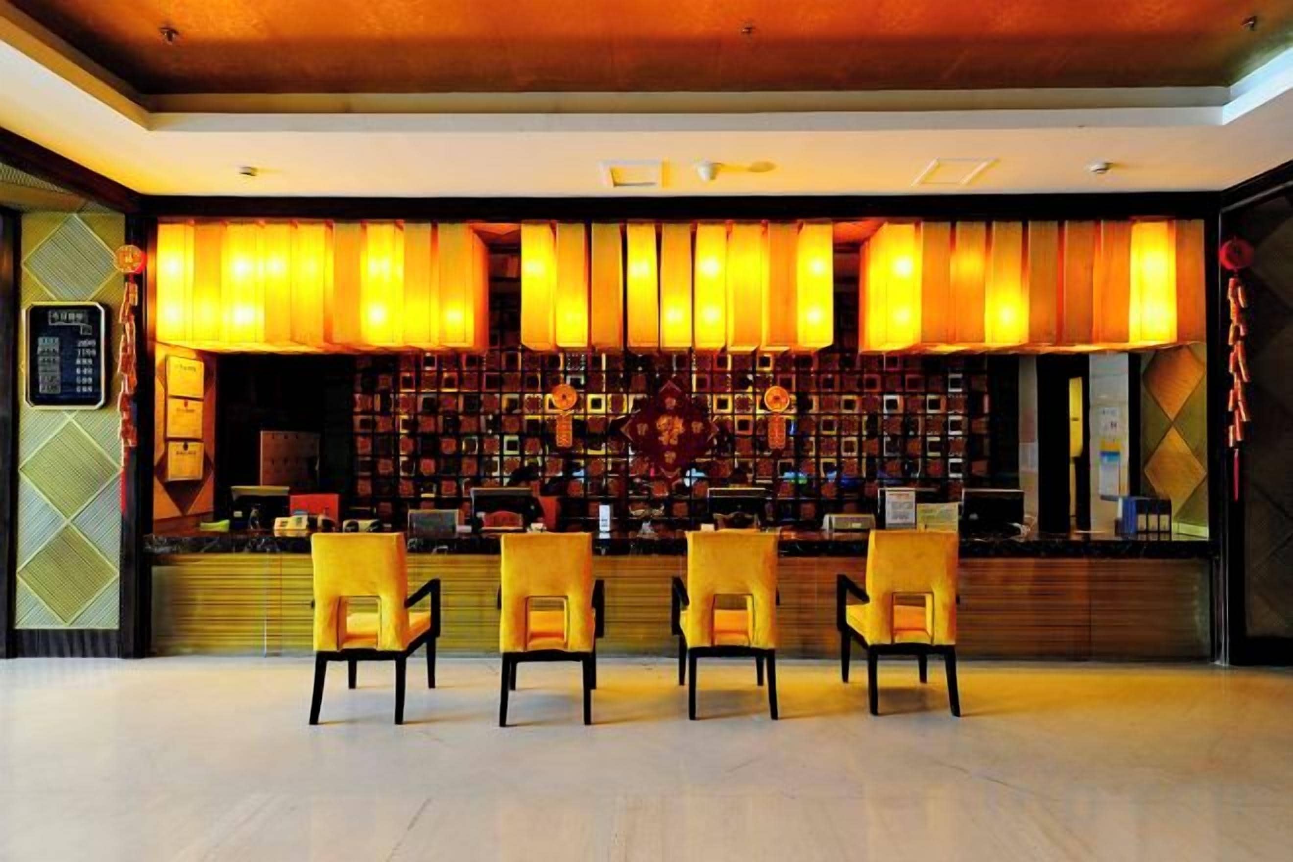 A bar area with a counter, bar stools, and a menu board.