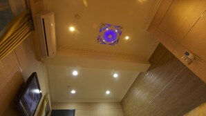 A hotel room with a ceiling fan, recessed lighting, and a television. - HF Keelung 61 (Keelung)