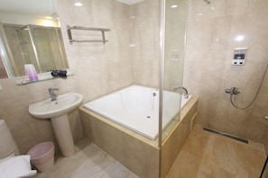 A modern bathroom with a glass-enclosed shower, a pedestal sink, and a built-in bathtub. - HF Keelung 61 (Keelung)