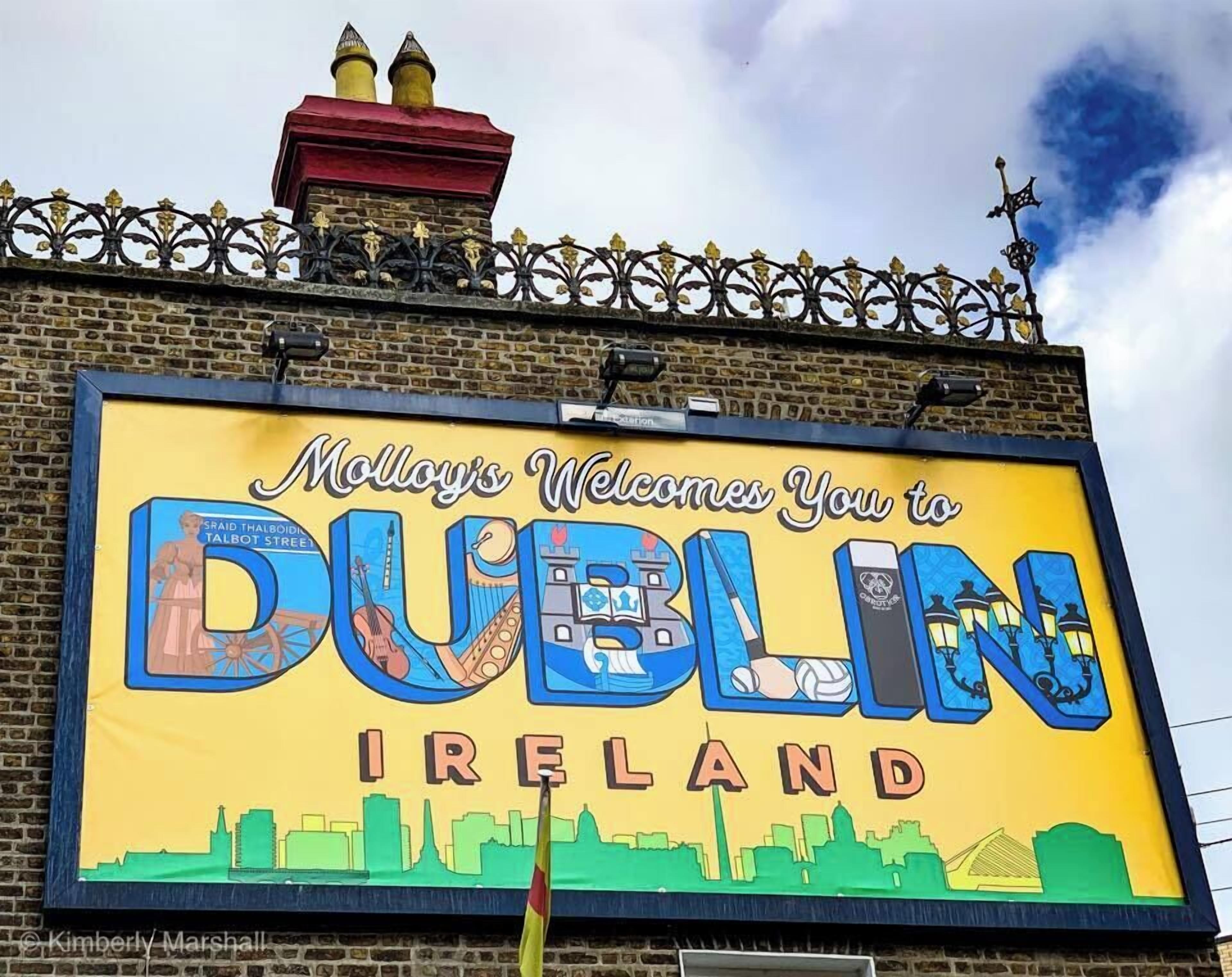 A large billboard with "Molly's Welcomes You to Dublin Ireland" and a cityscape illustration.