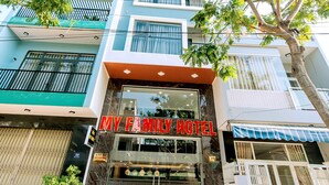 A hotel with a modern facade, large glass windows, and a prominent sign reading "MY FAMILY HOTEL". - My Family (Da Nang)