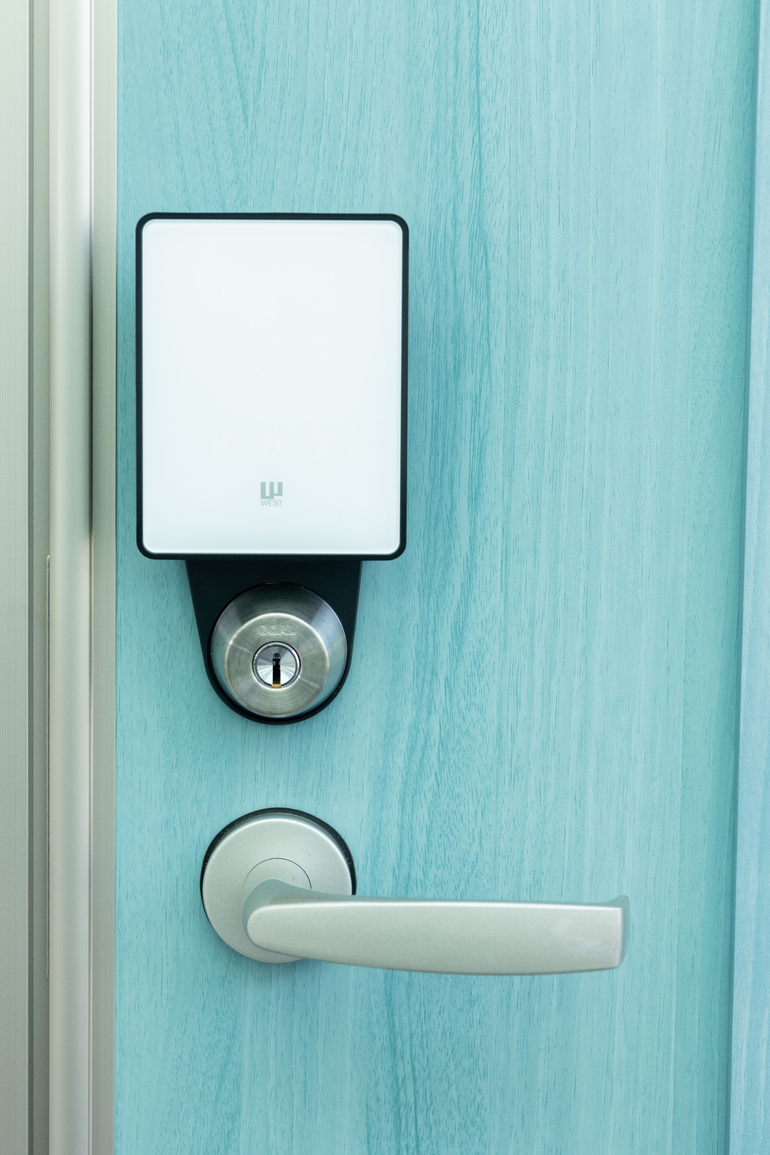 A door with a modern electronic lock and a keyhole.