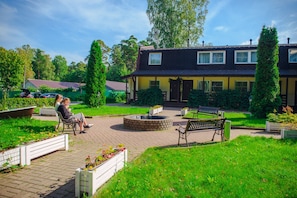 Relax and unwind in this serene garden area, complete with benches and a fire pit.