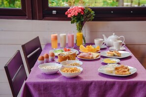 Enjoy a delicious breakfast spread with a variety of options, including cereal, eggs, and fresh fruit.