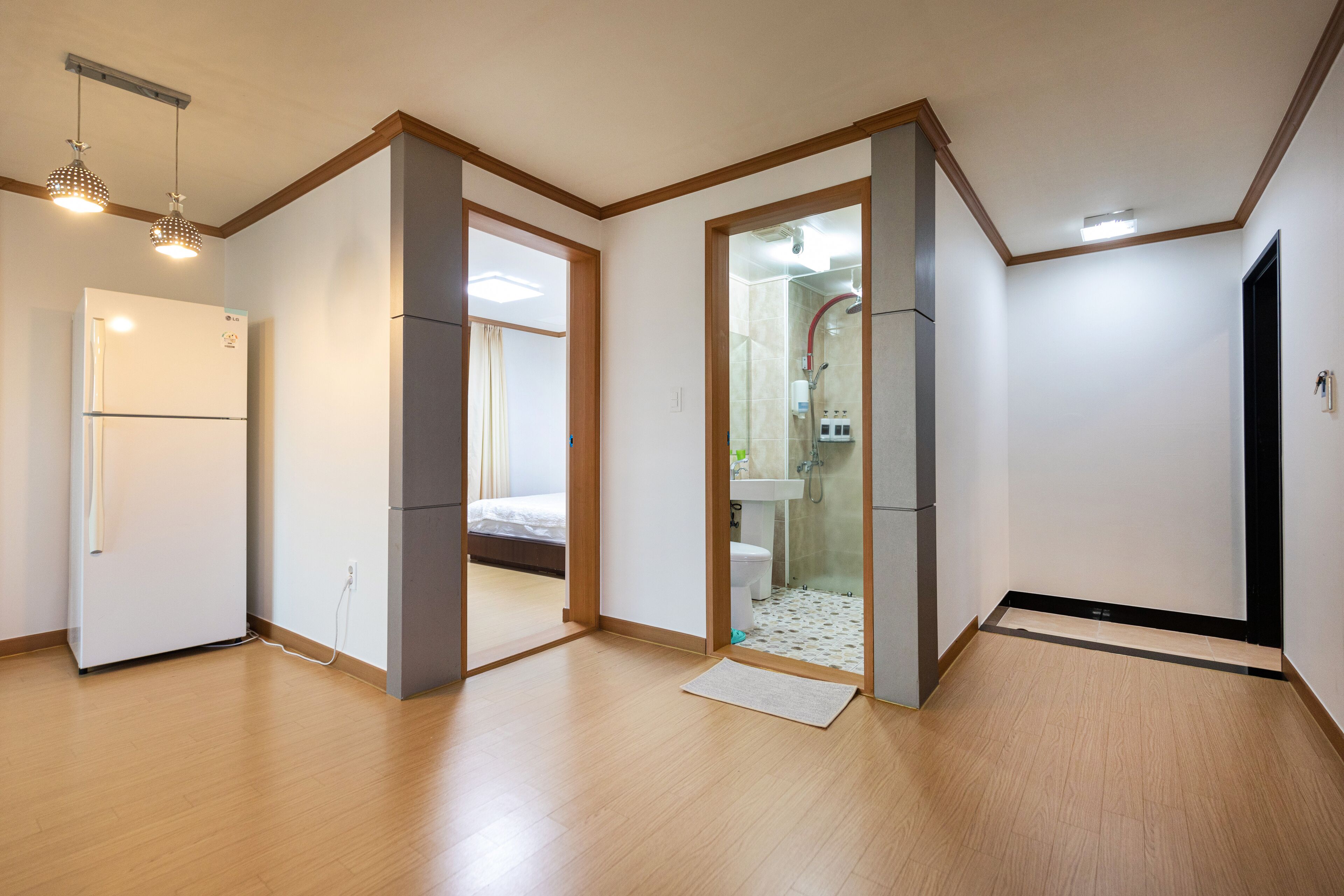 A modern apartment with a kitchen, a bathroom, and a bedroom.