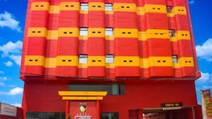 A red building with a 'Hotel' sign and a 'Drive-In' sign. - Hotel Sogo Alabang South Road (Muntinlupa)