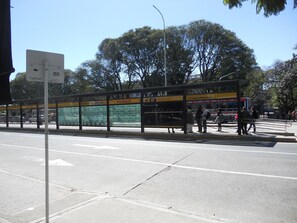A bus stop with a shelter, a sign indicating 'Centro de la Ciudad de Buenos Aires', and a bus approaching. - Santa Fe & Carranza By Foreign In Baires (Buenos Aires)