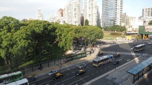A city street with a bus stop, vehicles, and high-rise buildings in the background. - Santa Fe & Carranza By Foreign In Baires (Buenos Aires)