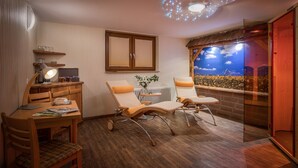 A cozy room with a wooden desk, two lounge chairs, a ceiling light, a window with a view, and a radiator. - Hotel Sonnenhof (Neuweiler)