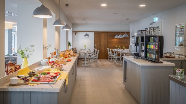 A breakfast buffet with various food items and a coffee station. - Hotel Sonnenhof (Neuweiler)