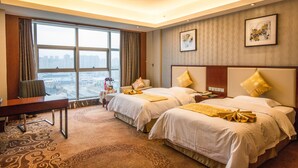 A hotel room with two beds, a desk, and a large window offering a city view. - Loudi Huatian Hotel (Loudi)