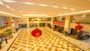 A spacious lobby with a checkered floor pattern, red lanterns, and a reception desk. - Loudi Huatian Hotel (Loudi)