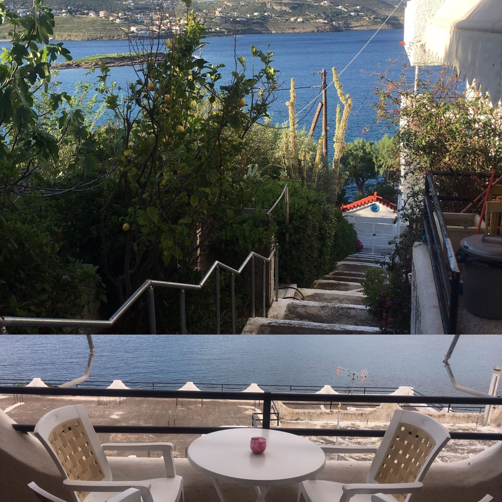 A terrace with a view of the sea, a white table, and two wicker chairs.