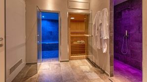 A modern bathroom with a glass shower enclosure, a wooden sauna, and a tiled floor. - Il Borgo di Villa Cellaia (Dicomano)