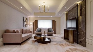 A modern living room with a sofa, two armchairs, a coffee table, a chandelier, and a fireplace. - Haifu Garden Hotel (Jinsha)