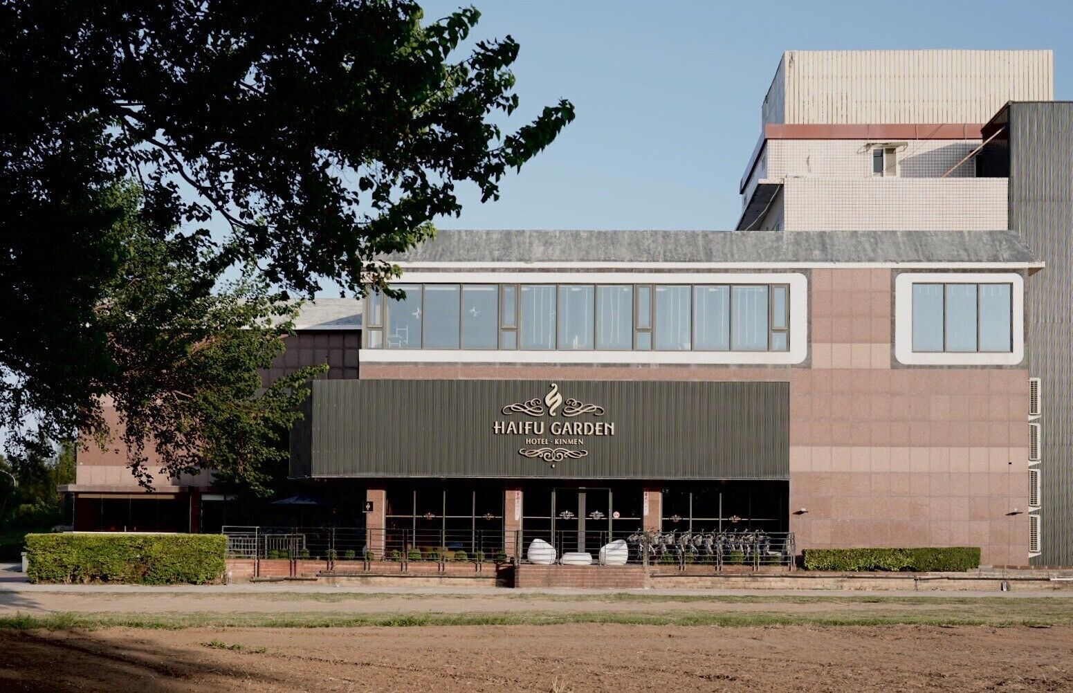 A modern building with a sign reading "HAIFU GARDEN HOTEL - KINMEN".