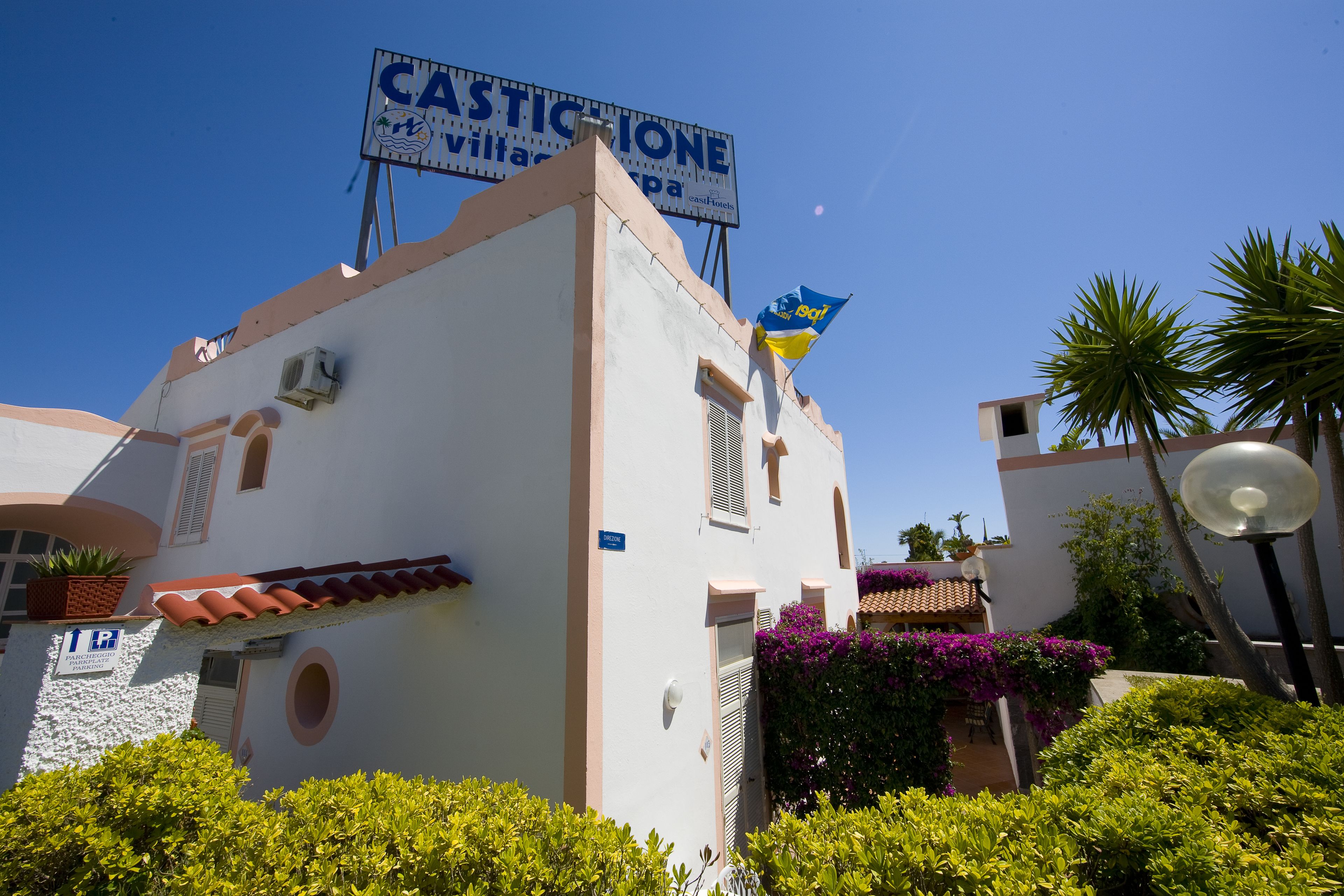 A building with a sign reading "CASTICIONE" and a flag.