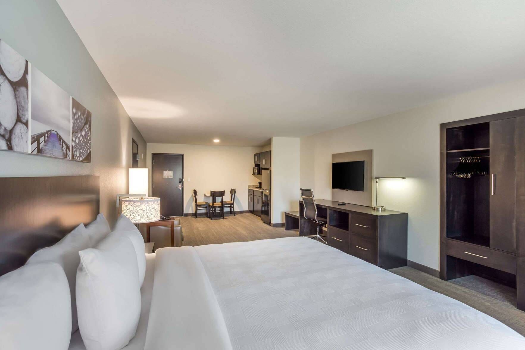 Premium bedding, desk, laptop workspace, blackout drapes