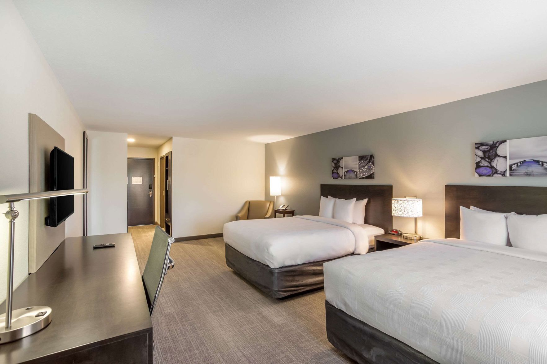 Premium bedding, desk, laptop workspace, blackout drapes