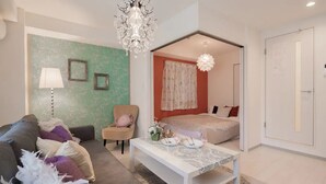 A modern bedroom with a bed, a sofa, a coffee table, and a chair. - Hatch NAGAHORI 701 (Osaka)