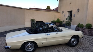 A cream-colored convertible car parked on a paved driveway. - La Part Des Anges (Mardeuil)