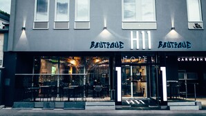 A boutique hotel with a modern facade, large windows, and outdoor seating area. - BOUTIQUE HOTEL11 with rooftop SPA (Nitra)