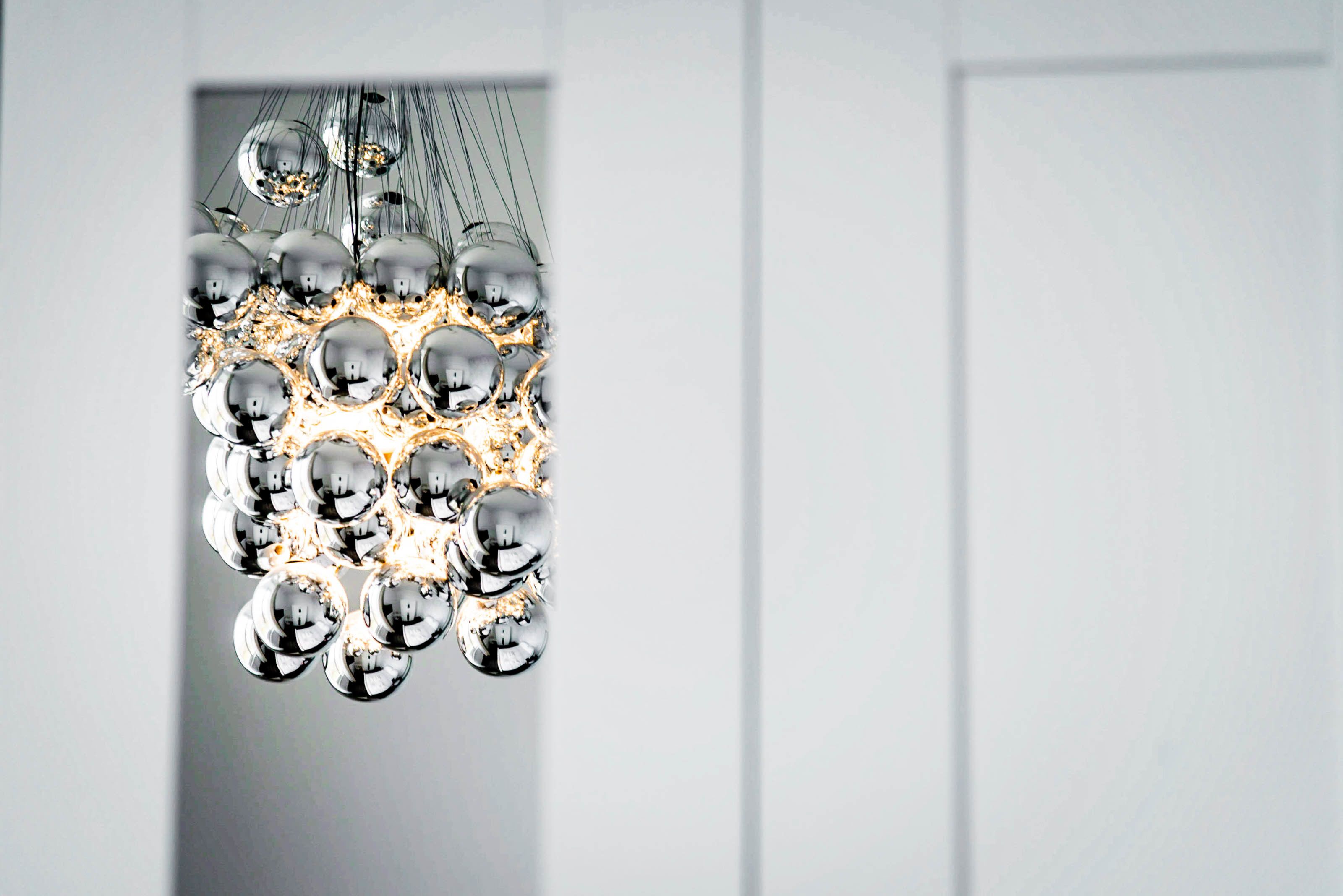 A modern chandelier with multiple spherical bulbs.
