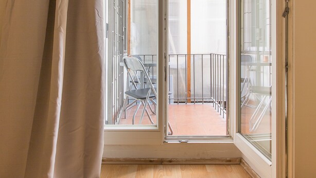 A room with a sliding glass door leading to an outdoor patio with a table and chairs. - Premier Apartment near Museum (Prague)