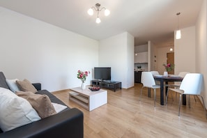 Economy Apartment | Living area | 42-inch flat-screen TV with cable channels, TV - P&O Apartments Obozowa (Warsaw)