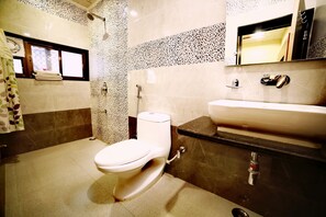 Un baño con inodoro, lavabo y ducha.