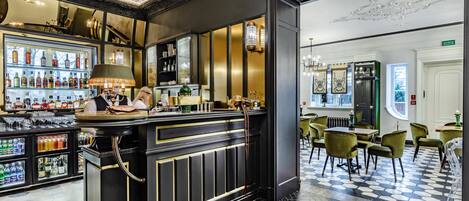A bar area with a counter, shelves of bottles, and a seating area with chairs.