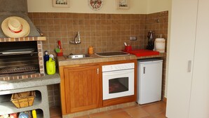 A compact kitchen with a built-in oven, a small refrigerator, and a sink. - Luxury Loft in Gran Canaria. Jacuzzi and Free WIFI. (Sta Brígida)