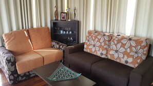 A living room with two sofas, a coffee table, and a cabinet with decorative items. - Luxury Loft in Gran Canaria. Jacuzzi and Free WIFI. (Sta Brígida)