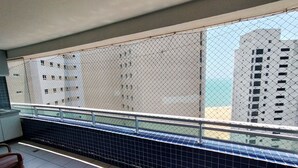 A balcony with a metal railing, tiled floor, and a chair. - Beach Class Residence by SOLEMAR (Fortaleza)