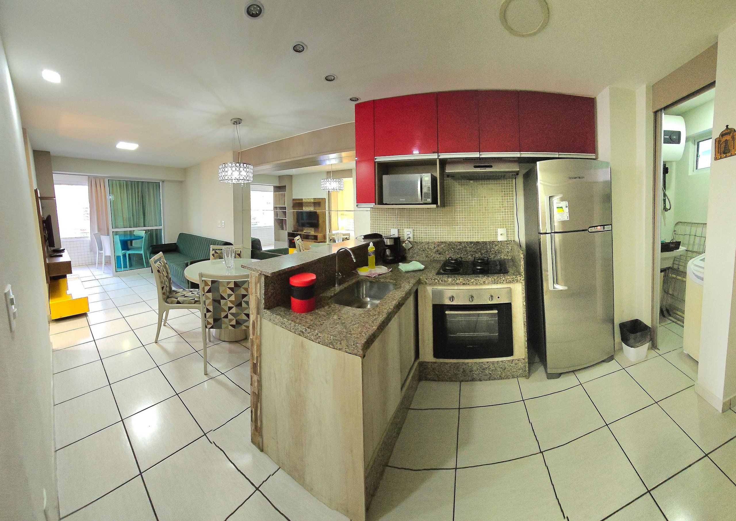 A compact kitchen with a microwave, stove, and refrigerator.