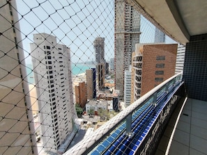 A high-rise building with a view of the cityscape through a chain-link fence. - Beach Class Residence by SOLEMAR (Fortaleza)