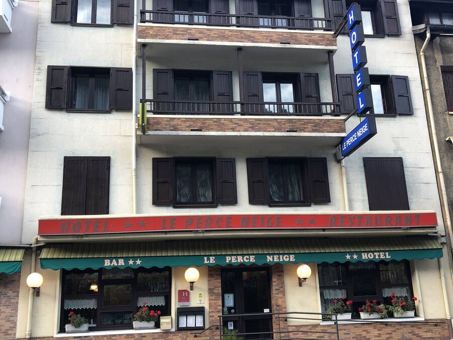 A multi-story building with a restaurant and hotel sign.