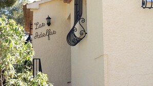 A building with a sign reading "Las Adelfas" and a decorative metal gate. - 0538 Villa Efaistos en el Montgo (Denia)