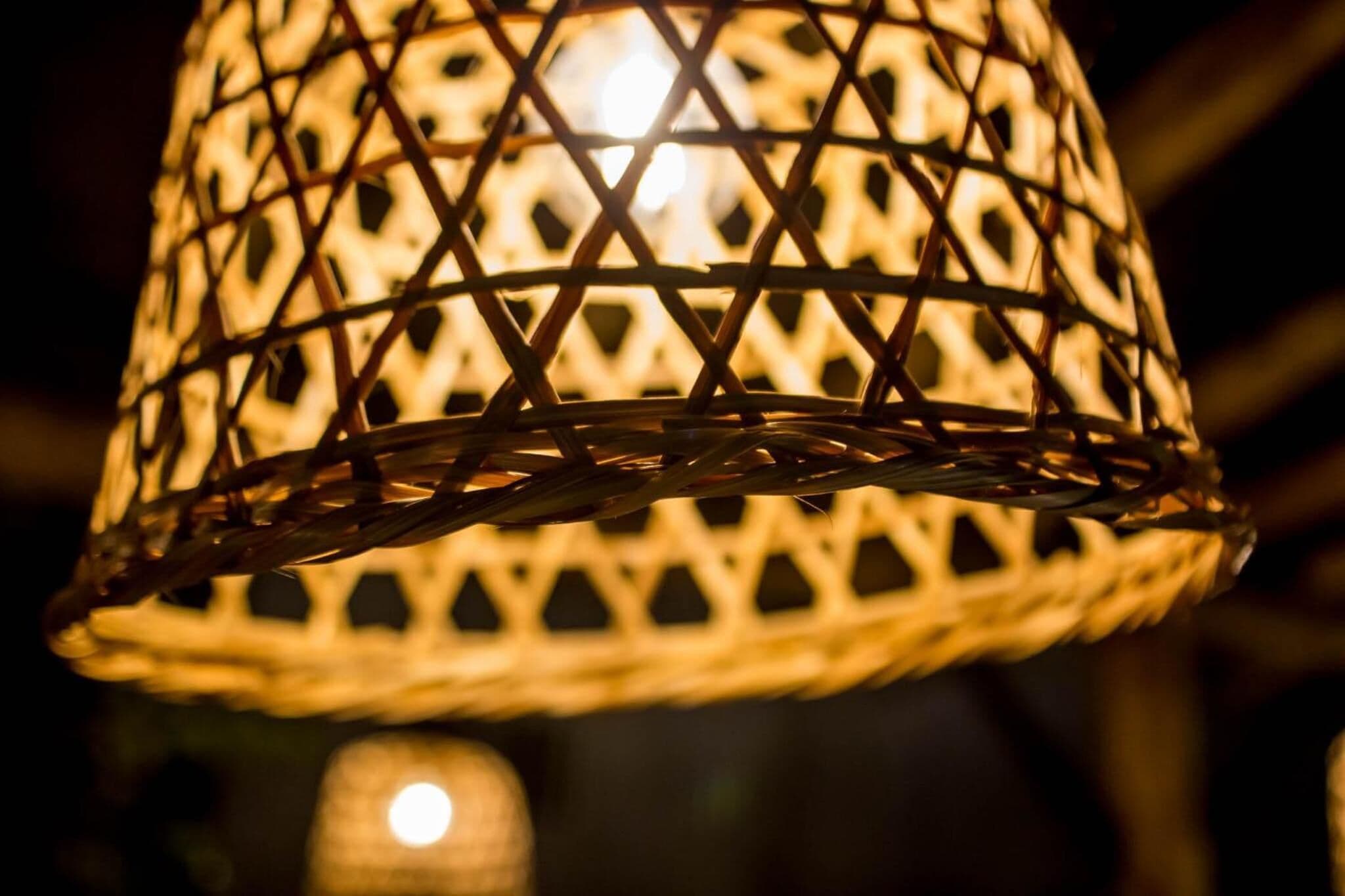 A close-up of a woven lamp with a geometric pattern.
