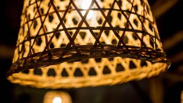 A close-up of a woven lamp with a geometric pattern.