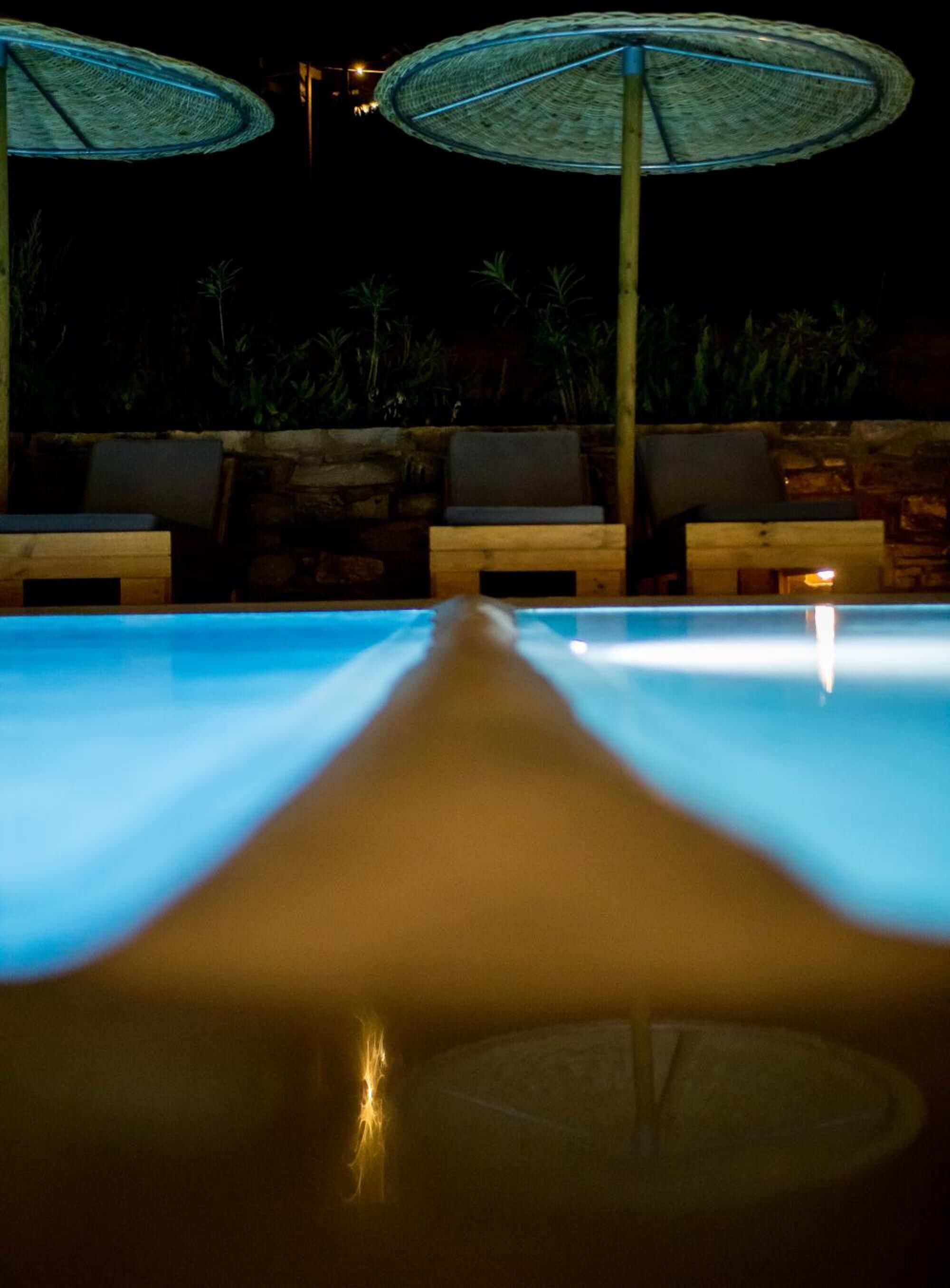 A poolside area with lounge chairs and umbrellas.