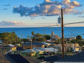 A coastal town with buildings, a church, and a view of the sea. - Brand-new Maui home with comfort and local charm! (Lahaina)
