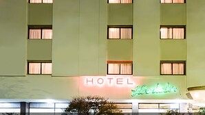 A hotel with a neon sign reading "HOTEL" and "Libertador."
