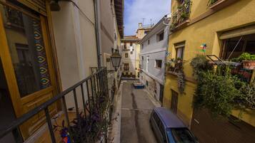 Stroll through a charming urban alleyway lined with residential buildings and balconies.