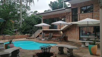 Outdoor pool, open 7:00 AM to 11:00 PM, pool loungers
