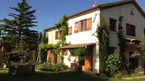 A two-story house with a white exterior, wooden shutters, and a tiled roof. - Chambres d'hôtes Lou Cliou (Cliousclat)